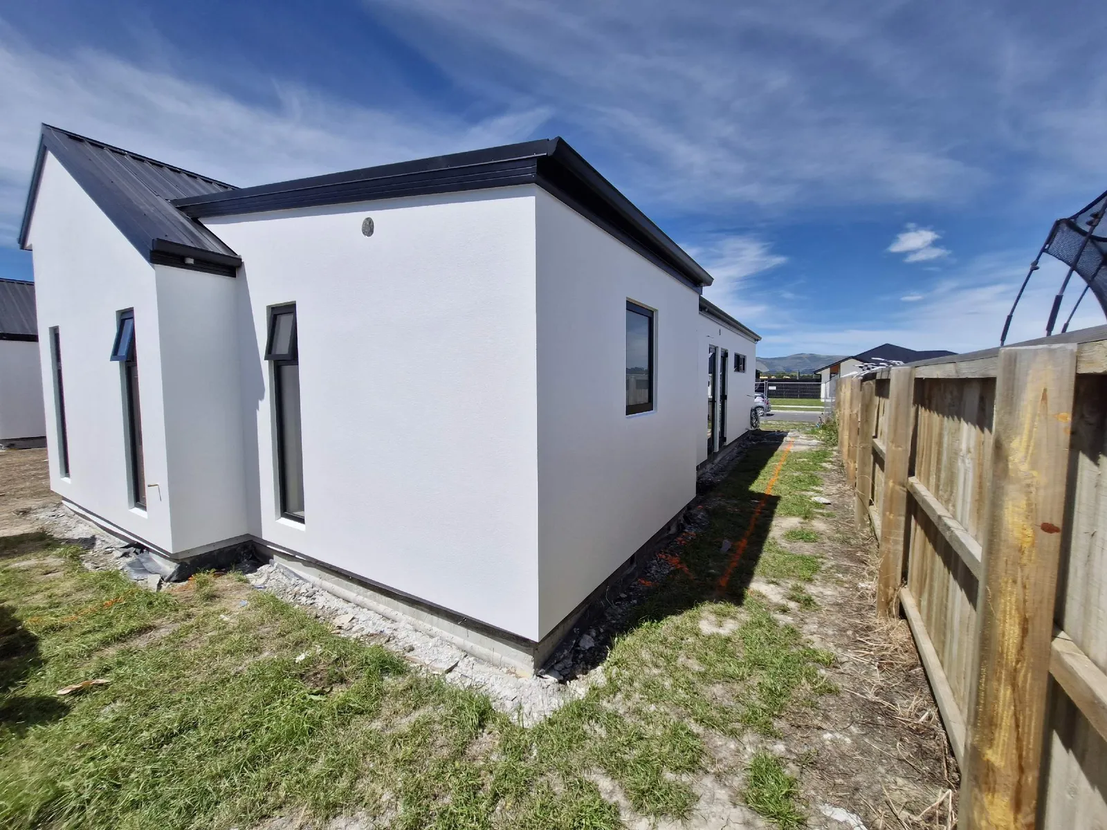 Two-storey home with white render finish
